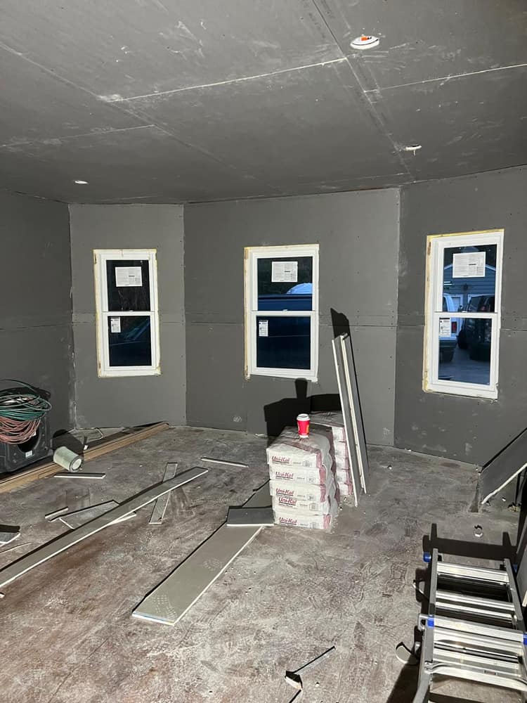 A finished interior room in warm gray with white-painted window trim.