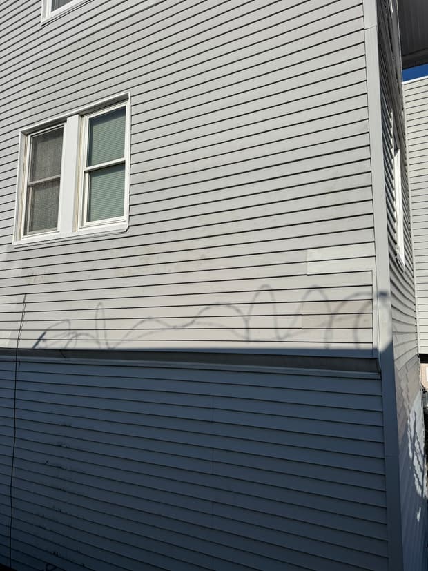 The finished run, a clean two-tone siding replacement with trim.
